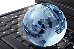 Crystal globe on laptop