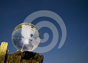 Crystal globe over blue sky