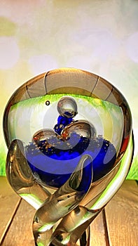 A crystal goblet stands on an oak table