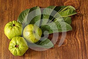 Crystal Guava fruit with leaves isolated on the wooden background
