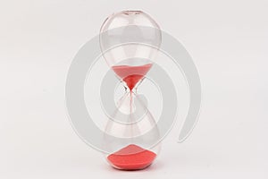 Crystal hourglass on light background as a concept of passing time for business term, urgency and outcome of time