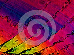 Crystal layer on microscope object glass, seen in polarized light. This causes random unforeseeable color effects