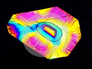 Crystal layer on microscope object glass, seen in polarized light. This causes random unforeseeable color effects