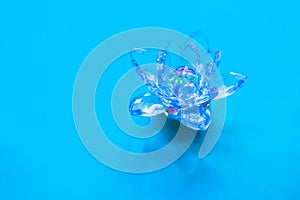 Crystal lotus on blue table. Vishuddha chakra symbol