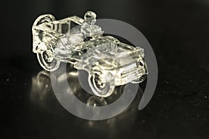 Crystal ornament that is a Jeep model car on a black background in which it is reflected
