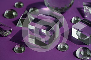 Crystal prism refracting light, magic crystals and pyramid, sphere and cube on purple background. Spiritual healing