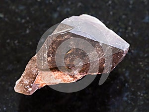 crystal of smoky quartz gemstone on dark