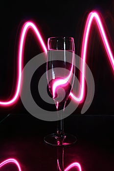 Crystal toasting glass decorated with luminous lines photo