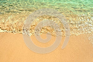 Crystal transparent waves on the sand beach. Koukounaries Beach.