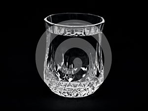 A crystall vodka glass over black