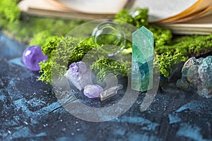 Crystalline minerals for meditation, moss, book. Magic Rock for Healing stones. Minerals for relaxation