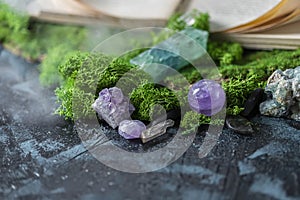 Crystalline minerals for meditation, moss, book. Magic Rock for Healing stones. Minerals for relaxation