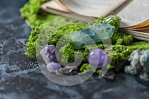 Crystalline minerals for meditation, moss, book. Magic Rock for Healing stones. Minerals for relaxation