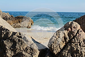 Crystalline waters and rock textures of Galapinhos Beach photo