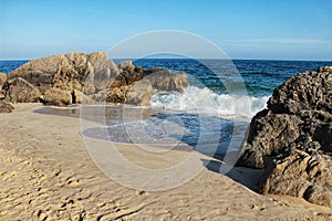 Crystalline waters and rock textures of Galapinhos Beach photo