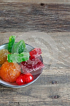 Crystallized fruits on rustic wood bottom.