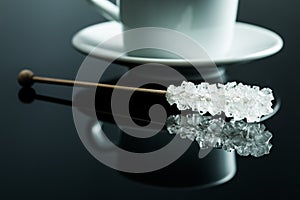 Crystallized sugar on wooden stick.