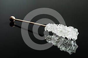 Crystallized sugar on wooden stick.