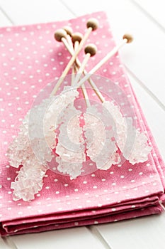 Crystallized sugar on wooden stick.