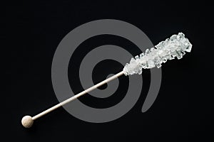 Crystallized sugar on wooden stick.