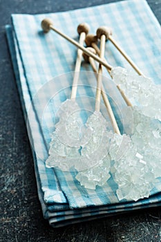 Crystallized sugar on wooden stick.