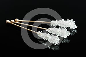 Crystallized sugar on wooden stick.