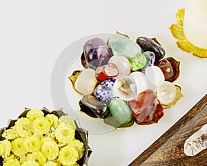 Crystals gemstones set, candle and dry flowers on white background