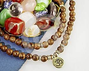 Crystals gemstones set with rosary beads on yoga mat