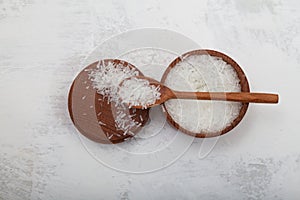 Crystals Glutamic acid monosodium salt in wooden spoon. Msg. Food additive E621. Flavor seasoning for enhancing food impressions.