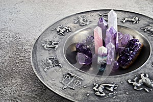 Crystals for healing, fortune telling and astrologhy circle on grey background. Esoteric and life coaching concept.