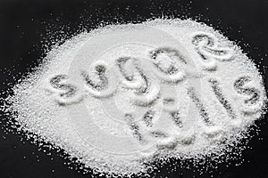 Crystals of sugar on a black background and the inscription