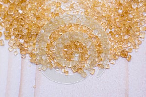 Crystals of Sugar.Brown cane sugar on white background