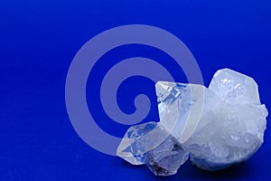 Crystals of white transparent quartz on a blue background