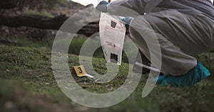 Csi, collect or evidence at crime scene for investigation in forest with safety bag or protection hazmat. Forensic