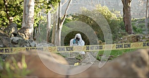 Csi, photographer and evidence at crime scene for investigation in forest with police tape and safety ppe. Forensic