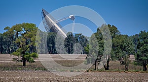 CSIRO Parkes radio telescope pointing to the sky from across the paddocks in NSW Australia photo