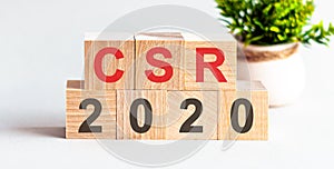 CSR 2020 word written on wood block. Faqs text on table, concept