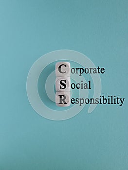CSR Business and Corporate Concept, Corporate Social Responsibility and Giving Back to Community, CSR icon on wooden cubes.