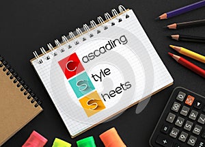 CSS - Cascading Style Sheets acronym on notepad, technology concept background