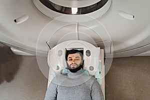 CT scan of brains of man in medical clinic. Man is doing computed tomography x-ray examination of tumor in his head in a