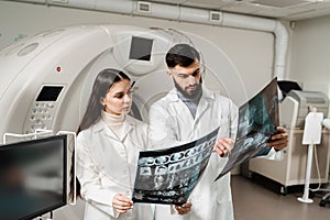 CT scan doctors are discussing x-ray of computed tomography of brains of patient. Computed tomography doctors are