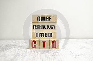 CTO abbreviation and magnifier on wooden background