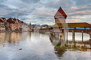 Ctyscape Lucerne Switzerland. Chapel Bridge across lake Lucerne with the Jesuit church on the banks of the lake. Landscape of amaz