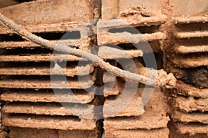 CU of muddy engine with mud-caked cooling fins on light motorcycle in Asia