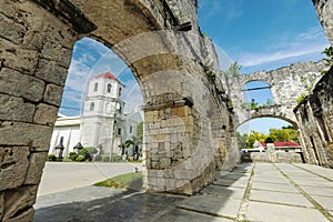 The Cuartel Ruins,and Our Lady of Conception Church,seen through an archway, Oslob,Cebu Island,The Philippines