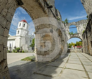 The Cuartel Ruins,and Our Lady of Conception Church,seen through an archway, Oslob,Cebu Island,The Philippines