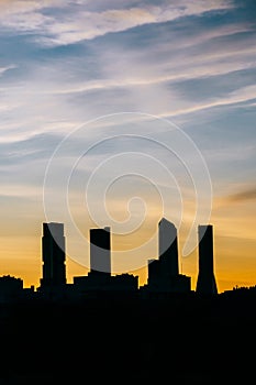Cuatro Torres Business Area Madrid skyline at sunset with high contrast in vertical photo