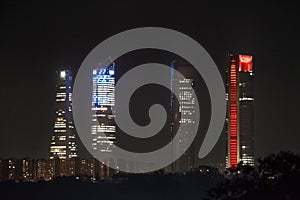 Cuatro Torres business area skyline at night in Madrid, Spain. photo