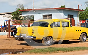 Cuba american yellow vintage car parked on the road