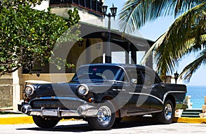 Cuba black american classic car on the beach